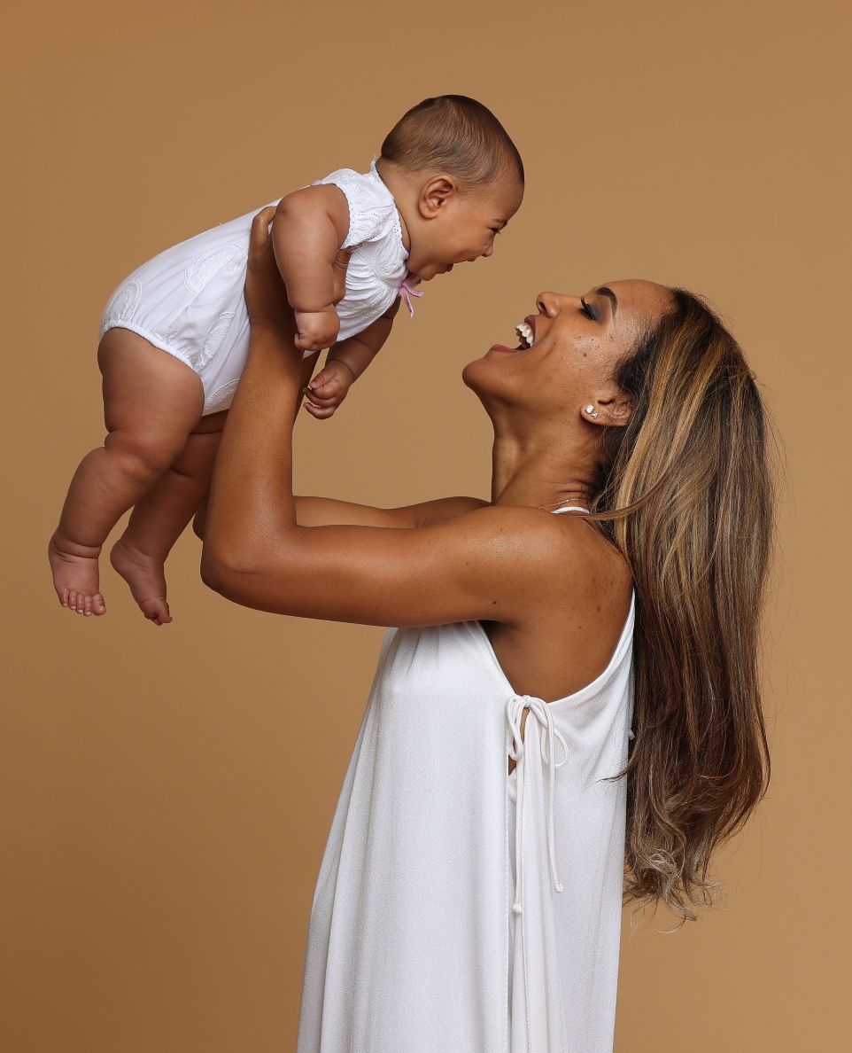 A mother lifting her baby with love